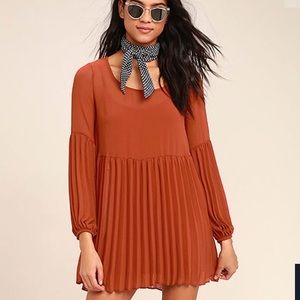 Rust red long sleeved pleated dress